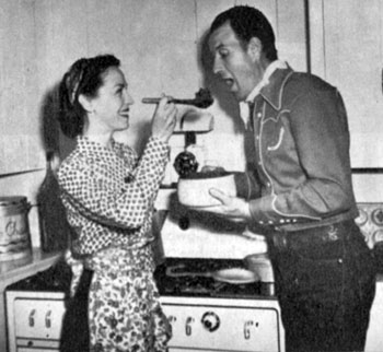 Bill Elliott’s wife Helen gives Bill a sample of her stew with vegetables from their own garden. Photo from 1944. They were married from 1927 til a divorce in 1961.