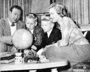 The "Frontier Doctor" Rex Allen and wife Bonnie have a geography session with sons Rex Jr. (Chico) and Curtis in mid-1959. The couple were married in '46 but later divorced.