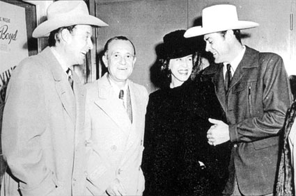 William Elliott, Republic producer Edward J. White, Mrs. Elliott and Allan Lane at a Hitching Post Theater screening. Note the William Boyd “Hoppy” poster on the left.