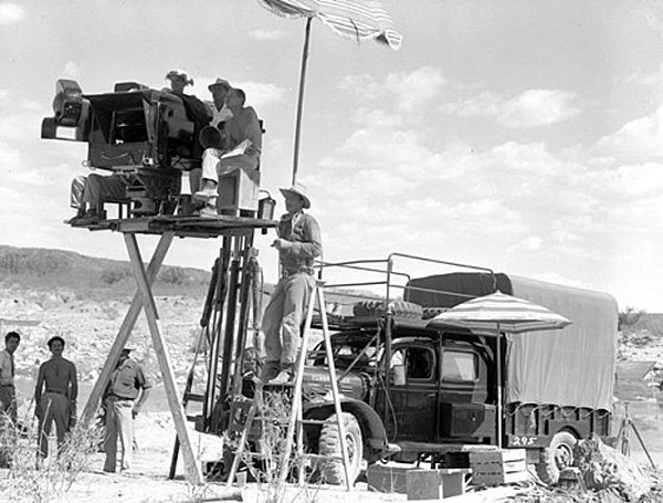John Wayne setting up a camera shot for “Hondo” (‘53 WB).