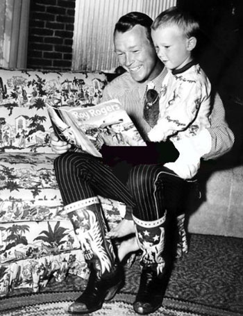 Christmastime as Roy reads one of his comic book adventures to son Dusty. (Thanx to Jerry Whittington.)