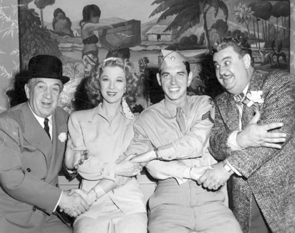 Comedians Hugh Herbert (left) and Billy Gilbert (right) join hands with Glenda Farrell and her son Tommy Farrell while Tommy was performing in “Winged Victory” (‘44) on Broadway. Tommy later co-starred in Westerns with Don Barry, Whip Wilson and others.