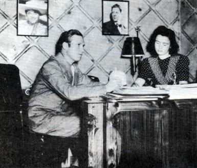 Gene dictates a letter to his secretary Dorothy Phillips. Note the pictures on the wall of Leo Carrillo and Rudy Vallee. Circa 1940.