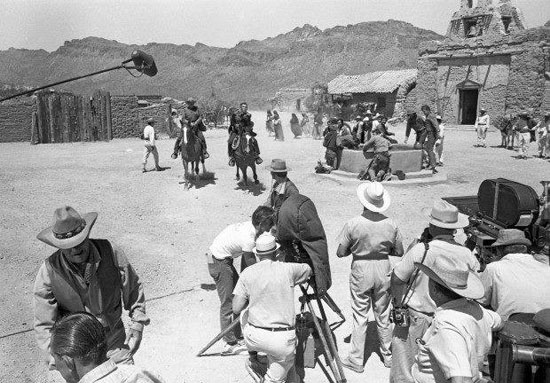 Shooting a scene for TV’s “High Chaparral” at Old Tucson. Don Collier and Cameron Mitchell are riding in. Mark Slade is in front of them and Leif Erickson is on the left. (Thanx to Marianne Rittner-Holmes.)