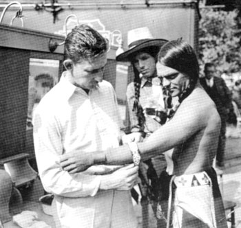Iron Eyes Cody watches as James Cagney is getting dressed as an Indian for “Lady Killer” (‘33 Warner First-National). The basically non-Western film had gangster Cagney making it big in Hollywood before his old life caught up with him.