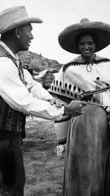 Yul Brynner shows off his fast draw for Israeli actress Daliah Lavi on the set of “Catlow” in Almeria, Spain on May 21, 1971.