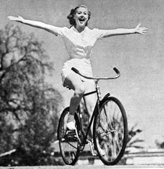 “Look Ma, no hands!” Adele Mara shows off on her bike in March 1943.
