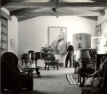Buck stands before his painting in his home.