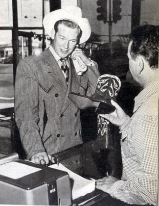 In late 1948, preparing for his starring days at Republic, Rex Allen looks over a pair of hand tooled boots at Nudie’s Western Wear shop.