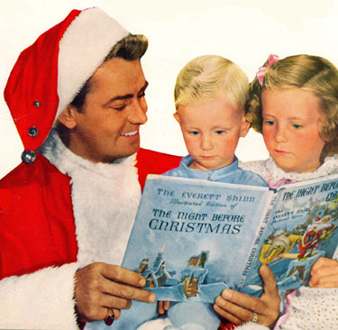 Alan Ladd reads a Christmas story to his children, David and Alana, Christmas 1949.