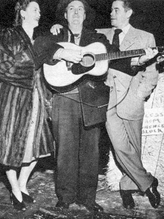 Smiley Burnette serenades the Fords...Eleanor Powell and Glenn Ford at the Hitching Post Theatre in the Fall of ‘47.