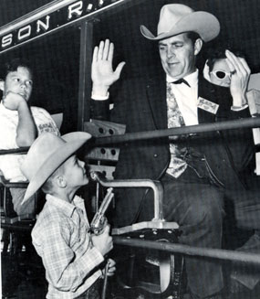 Young George Masek of Tucson holds a gun on “Tales of Wells Fargo” star Dale Robertson at the official dedication of Old Tucson in January 1960.
