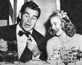 Republic Western star Rod Cameron seems to be telling a funny story to Monogram leading lady Reno Browne at a 1950 dinner party.