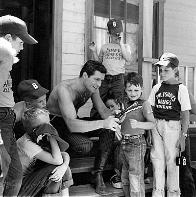 Using his Buntline Special, Hugh (“Wyatt Earp”) O’Brian talks gun safety to a group of youngsters. Note two boys are wearing “James Arness Beavers” tee-shirts.