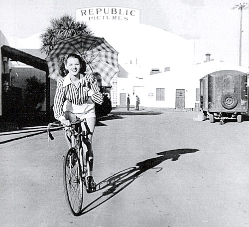 Adrian Booth takes a bike ride around the Republic backlot in 1946.