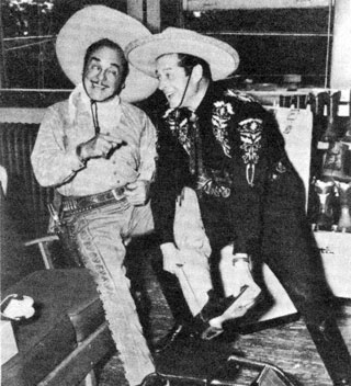 The Cisco Kid (Duncan Renaldo) fits sidekick Pancho (Leo Carrillo) with a pair of boots at the H. J. Justin and Sons plant’s 75th Anniversary in Fort Worth, Texas.