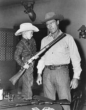 Fraser Heston, Charlton Heston’s son, gets the drop on “The Rifleman” with Chuck Connors’ own Winchester.