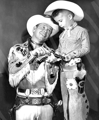 ex Allen dispenses a little six-gun instruction to a young fan.