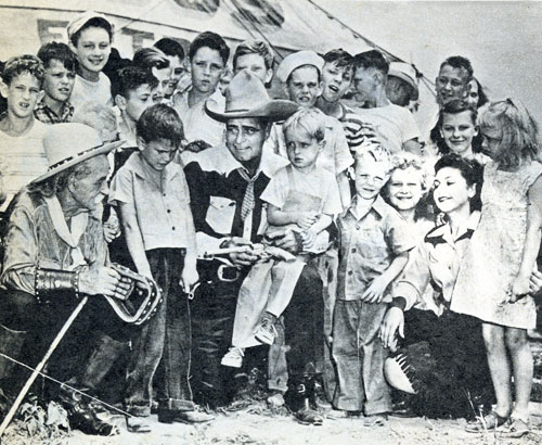 Silent and early ‘30s B-Western star Jack Hoxie surrounded by a group of admiring fans.