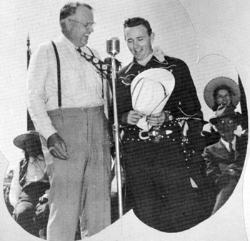 Oklahoma Governor Robert S. Kerr and Jimmy Wakely sing a duet and do a little kidding at the dedication ceremonies of a Chisholm Trail marker in Enid, Oklahoma in the mid ‘40s. Kerr was Governor from ‘43 to ‘47.