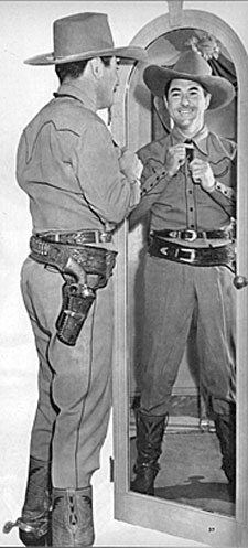 Johnny Mack Brown straightens his tie and gets ready for a day at the studio.