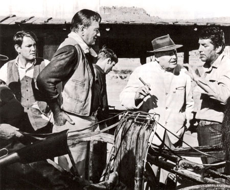 Director Henry Hathaway talks over a scene for “The Sons of Katie Elder” with Earl Holliman, John Wayne and Dean Martin.
