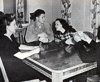 In 1948, Audie Murphy and his soon-to-be wife actress Wanda Hendrix play cards with Wanda’s parents. The couple were married in 1949.