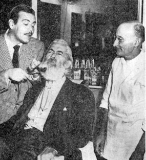 Gabby Hayes gets his beard trimmed by comedian Billy De Wolff while barber R. D. Carothers supervises. The stars were at the Southern Pacific terminal in Houston for the opening there of “Albuquerque” on 2/4/48.