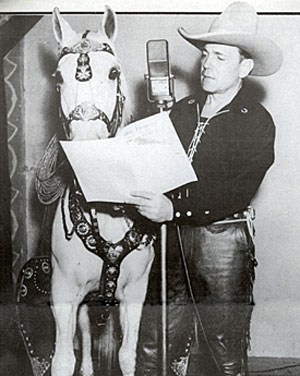 Buck Jones shares a script of his 1937 radio series “Hoofbeats” with his great horse Silver.