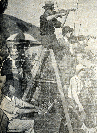 Live music was often played on the set of silent films to inspire the actors. This rare 1920s photo shows Rudolph Berliner, a former symphony orchestra conductor who was then a studio musical director, playing a violin on the top step of a ladder.