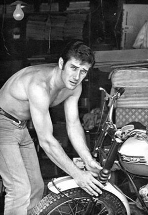 “Laramie” star Robert Fuller prepares to take a ride on his motorbike. (Thanx to Terry Cutts).