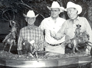 Team roper Joe Crow (left) and his favorite roping partner Ben Johnson (right) flank sculptor Edd Hayes at a Ben Johnson/Bum Phillips Celebrity Roping and Cutting in Houston, Texas. Hayes created the 110 lb. bronze which sold for $62,000 at auction.