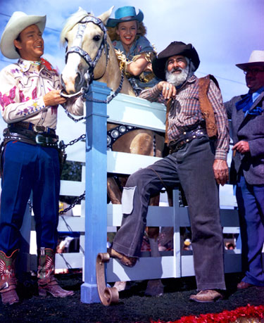 Roy Rogers, Dale Evans on Trigger and Gabby Hayes during a rodeo performance. 