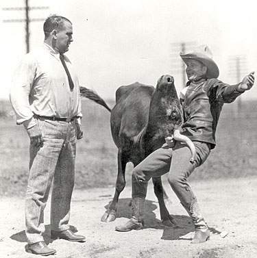 World Champion cowboy Yakima Canutt shows four time World Heavyweight Championship Wrestler Ed “Strangler” Lewis how to hold ‹em with one hand.
Photo circa late ‘20s-very early ‘30s. 
