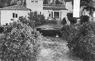 Roy Rogers waves from the front porch of his San Fernando Valley home circa 1942. Property had a swimming pool, tennis court, guest house, citrus orchard and huge corral.