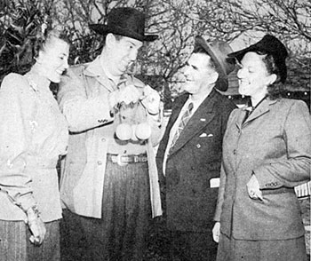 Smiley Burnette brags about his California oranges to Polly Jenkins (right) and another lady, unaware Uncle Dan owns a Florida orange grove. (1947)