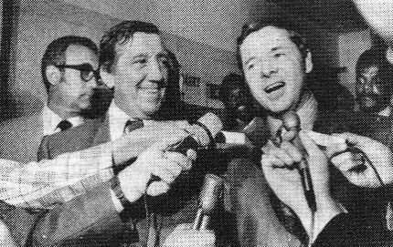 Audie Murphy faces newsmen in 1970. Man with Audie is Paul Caruso, his attorney when Audie was charged with the attempted murder of a kennel owner in a dispute over a dog. Audie was acquitted. (Thanks to Vic Mizzone.)