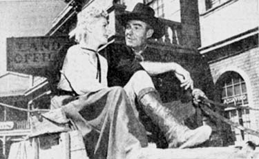 Lucille Norman and Randolph Scott take a break from filming “Carson City” (‘52 WB).