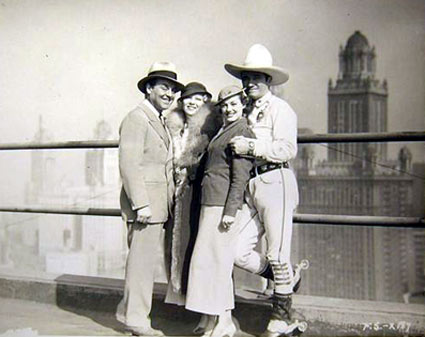 Leo Carrillo and Tom Mix pose with two lovely ladies in Chicago in 1933.