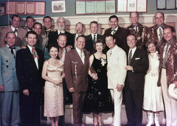 (L-R Top Row) Sons of the Pioneers: Dale Warren, Tommy Doss, Shug Fisher, Lloyd Perryman. Gabby Hayes, unknown, George Gobel, Pat Buttram, Cass County Boys: Fred Martin, Bert Dodson. (L-R Bottom Row) Sons of the Pioneers: Karl Farr. Tex Williams, Connie Haines, Pat Brady, Gene Autry, Dale Evans, Roy Rogers, Ralph Edwards, Gail Davis, Jerry Scoggins of the Cass County Boys. We’re not sure but believe this photo was taken during Gene Autry’s “This is Your Life” TV program with Edwards. (Photo courtesy Dale Price via Gail Davis.)