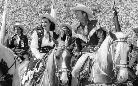 Dale Evans and Roy Rogers before a crowd of over 100,000 at the Sheriff’s Rodeo at the L. A. Coliseum in 1949.