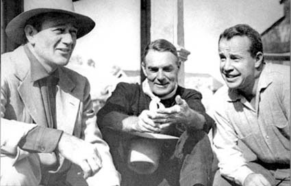 Classic photo of John Wayne, Randolph Scott and director Budd Boetticher on the set of “7 Men From Now” which starred Scott and was produced by Wayne’s Batjak Productions.