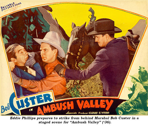 Eddie Phillips prepares to strike from behind Marshal Bob Custer in a staged scene for "Ambush Valley" ('36).