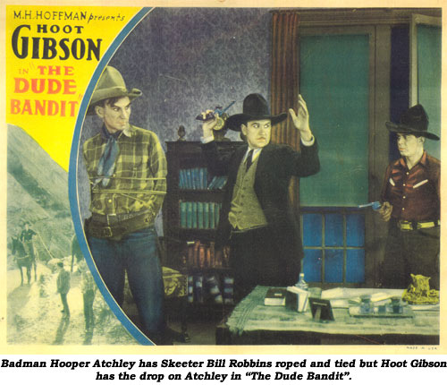 Badman Hooper Atchley has Skeeter Bill Robbins roped and tied but Hoot Gibson has the drop on Atchley in "The Dude Bandit".