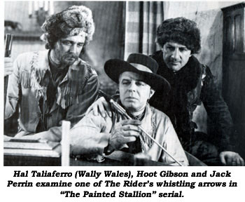Hal Taliaferro (Wally Wales), Hoot Gibson and Jack Perrin examine one of The Rider's whistling arrows in "The Painted Stallion" serial.