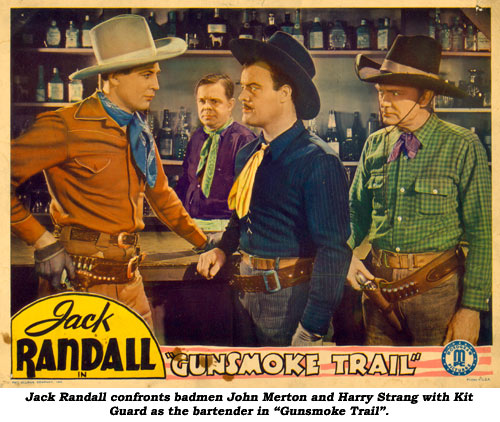 Jack Randall confronts John Merton and Harry Strang with Kit Guard as bartender in "Gunsmoke Trail".