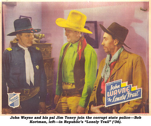 John Wayne and his pal Jim Toney join the corrupt state police---Bob Kortman, left---in Republic's "Lonely Trail" ('36).