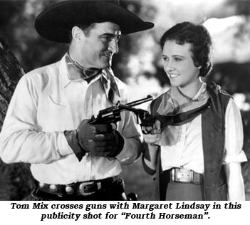 Tom Mix crosses guns with Margaret Lindsay in this publicity shot for "Fourth Horseman".